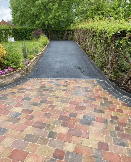Drainage channel set into a block paved driveway by Marshall Driveways Ltd