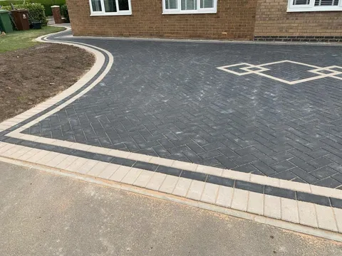 Charcoal herringbone block paving driveway with diamond inlay installed by Marshall Driveways Ltd